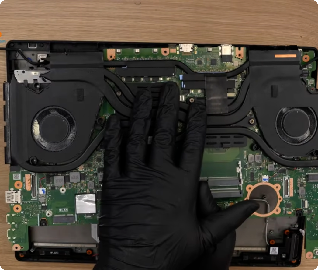 H7604J motherboard replacement: lifting the defective logic board out of the ASUS ProArt Studiobook 16 OLED chassis.
