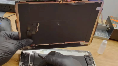 iPad Pro 11 M4 screen replacement showing the separated OLED display panel and open aluminum chassis.